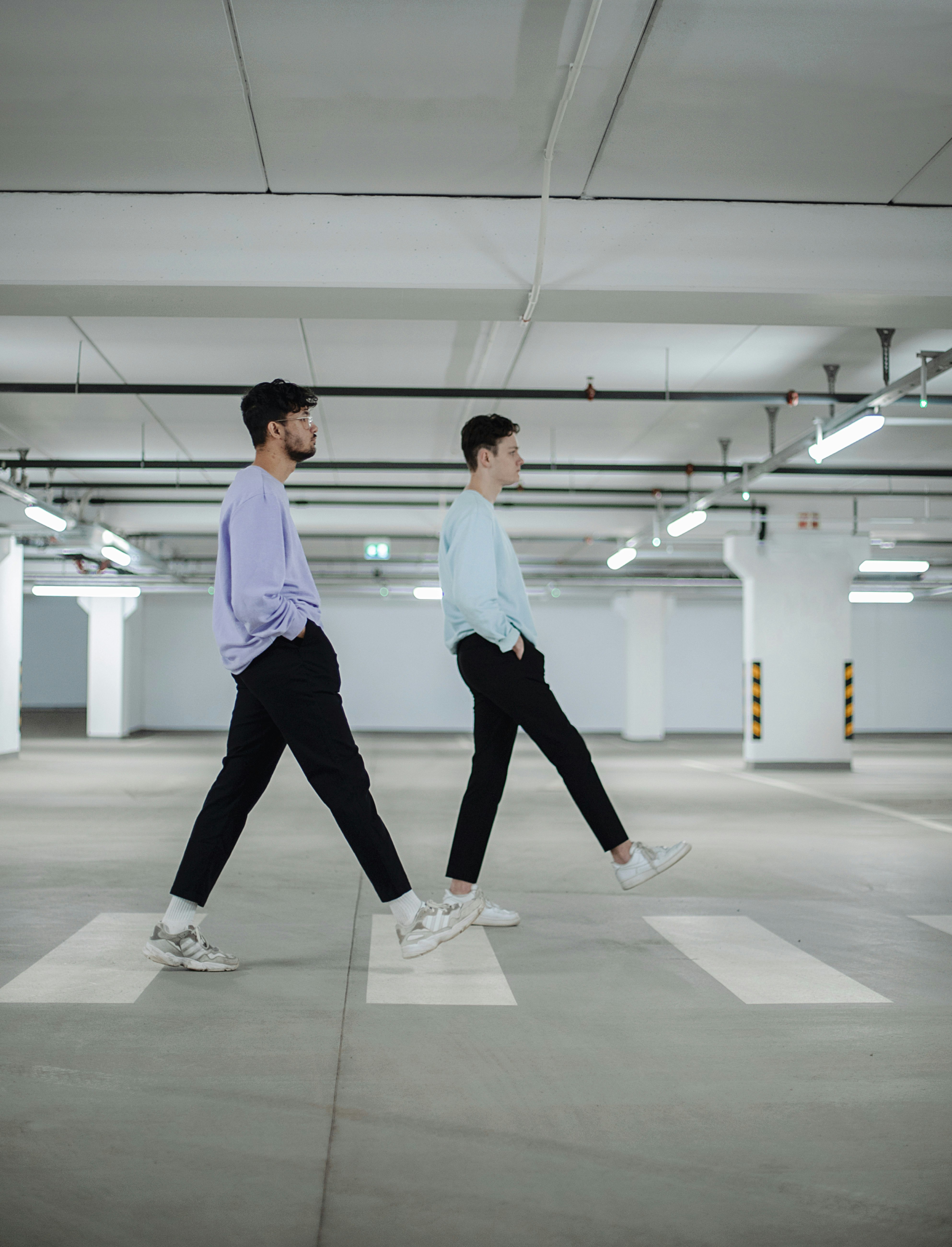 man in white shirt and black pants standing beside woman in white shirt